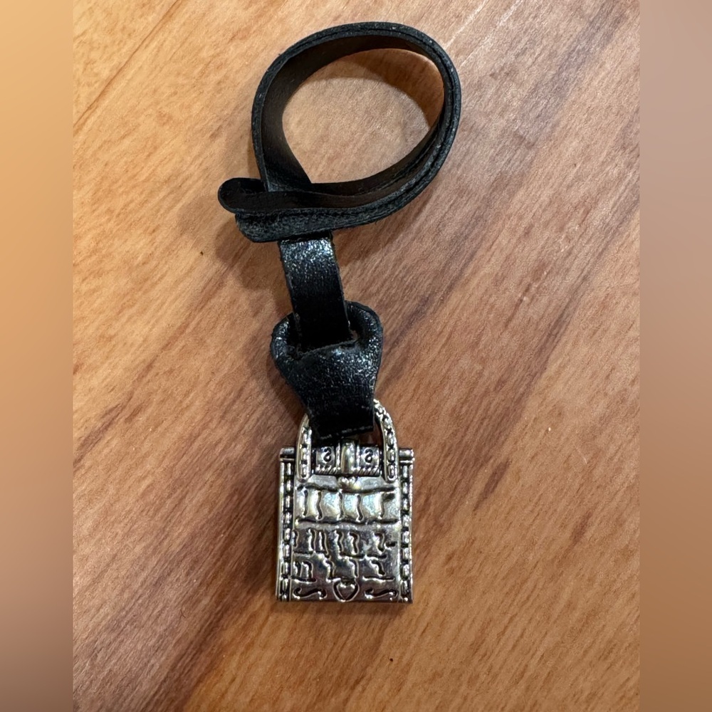 Bag shaped silver toned bag charm on leather strap